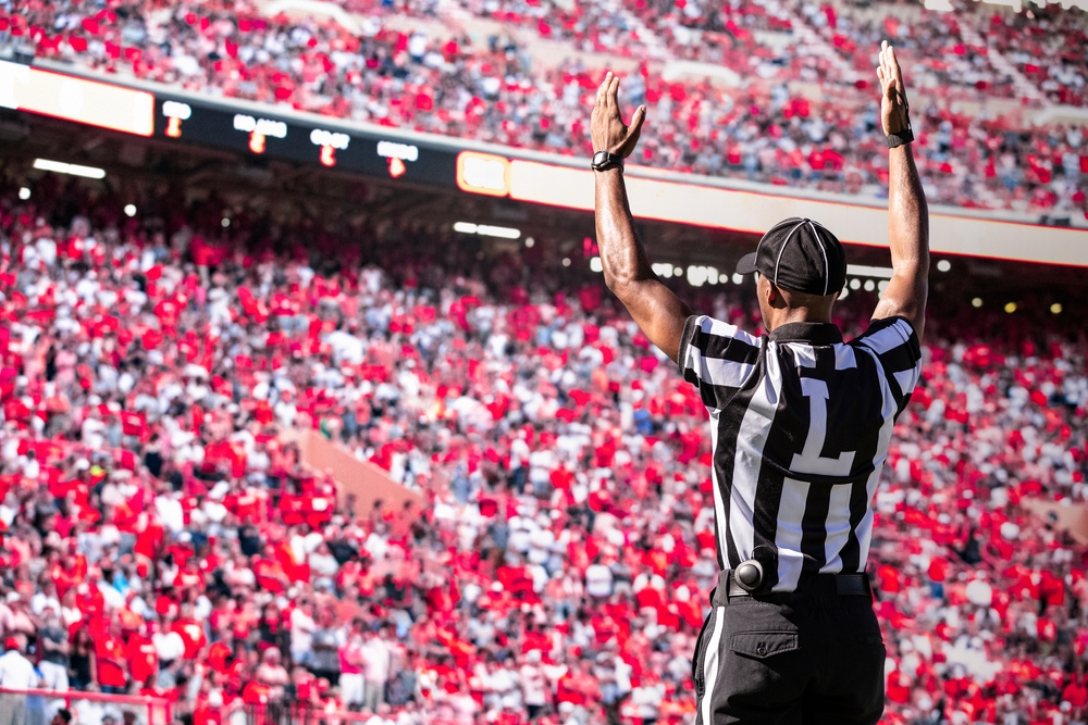 Referee signals a touchdown at a football game - car insurance in Georgia